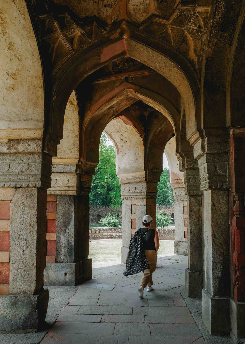 humayun temple-femme-delhi-inde-R0006950 repérage agence Magali marchant sous les arcades d'un monument dans le complexe du tombeau d’Humayun à Delhi, en Inde